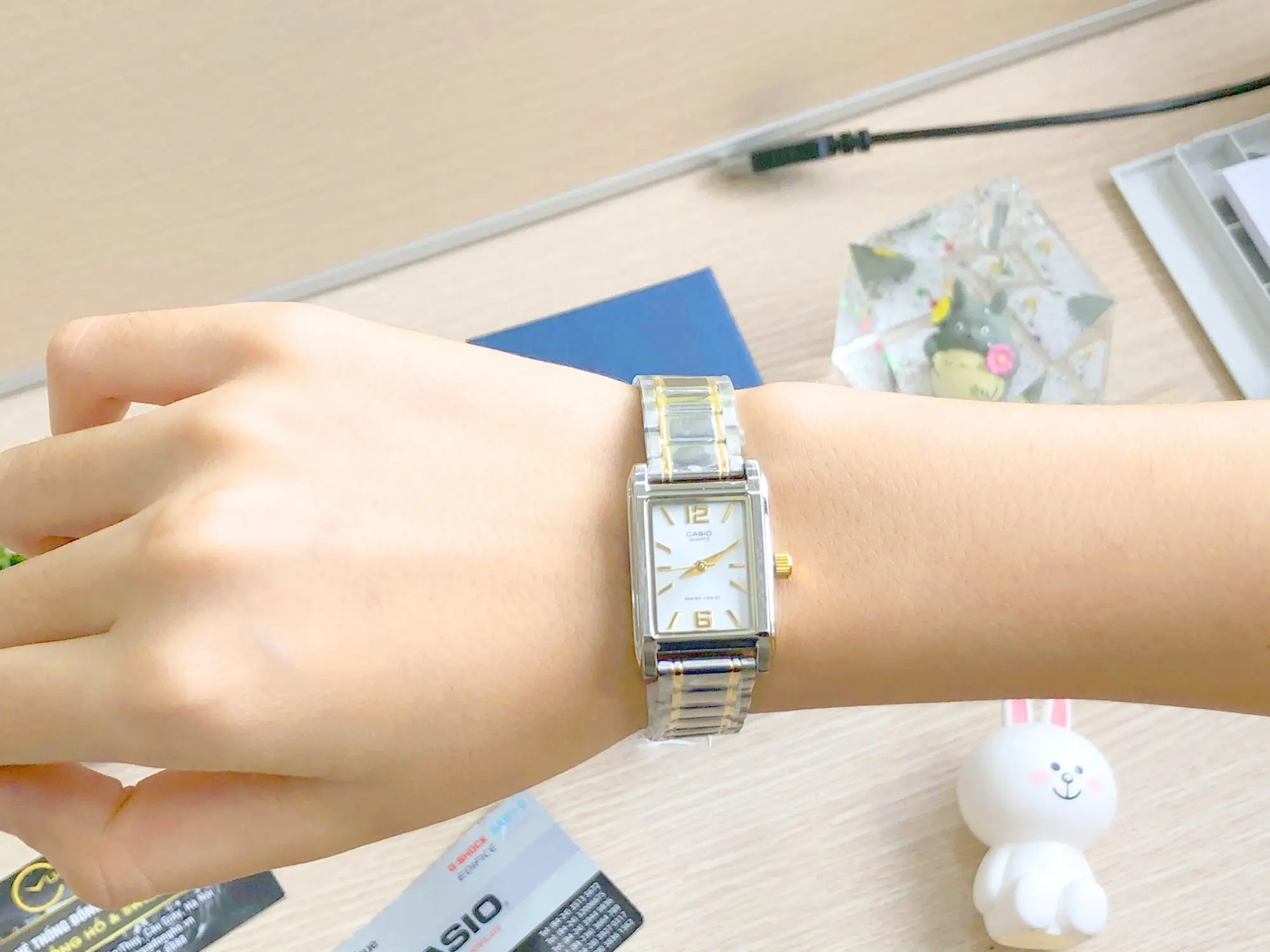 Elegant silver and gold Casio watch on display
