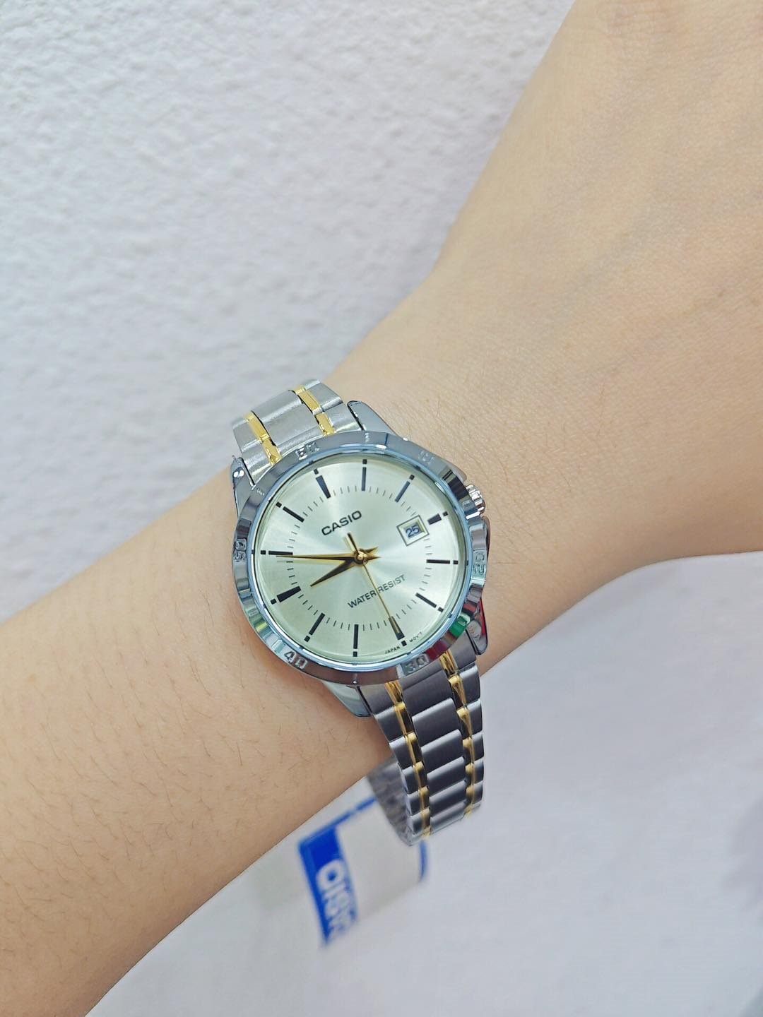 Close-up of champagne dial and date window
