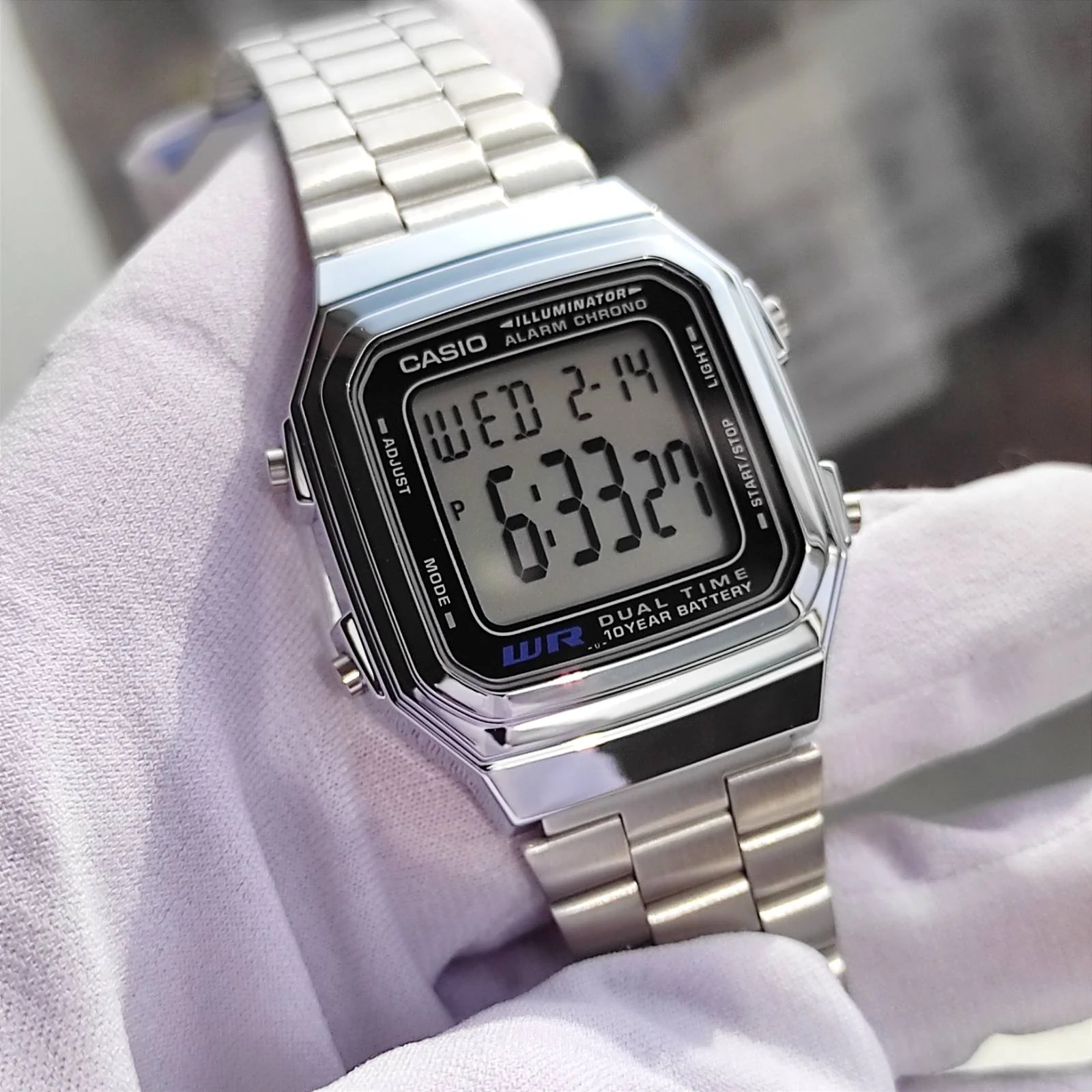 Side view of stainless steel Casio digital timepiece
